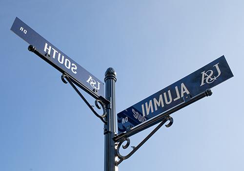 Alumni and South street signs.