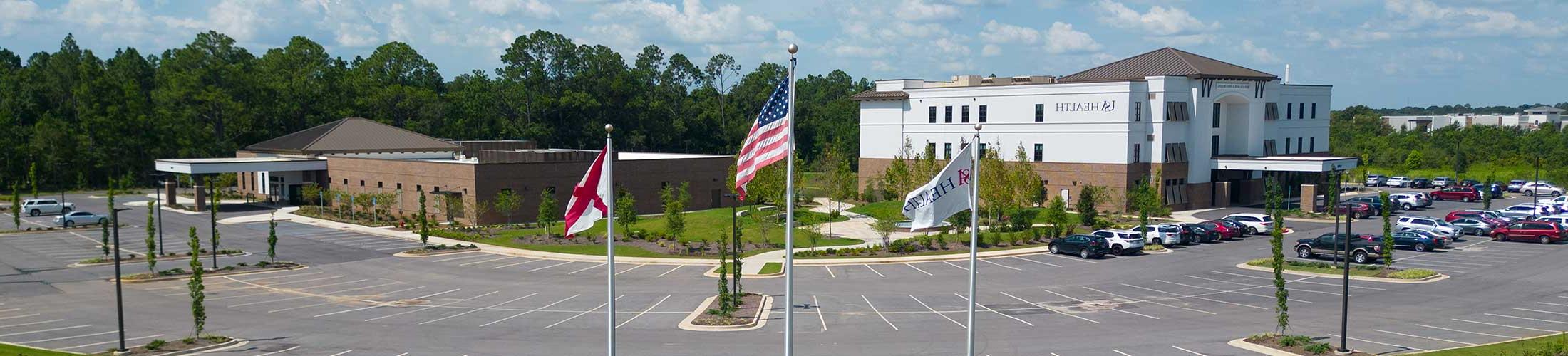 USA Health facility with flags in front.