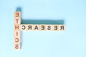 Scrabble pieces spelling out the words Research and Ethics.